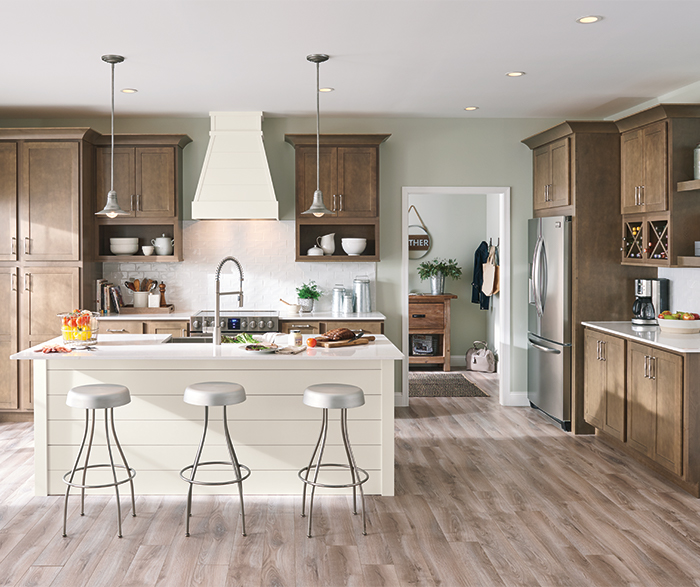 casual kitchen with stained birch cabinets and white painted island